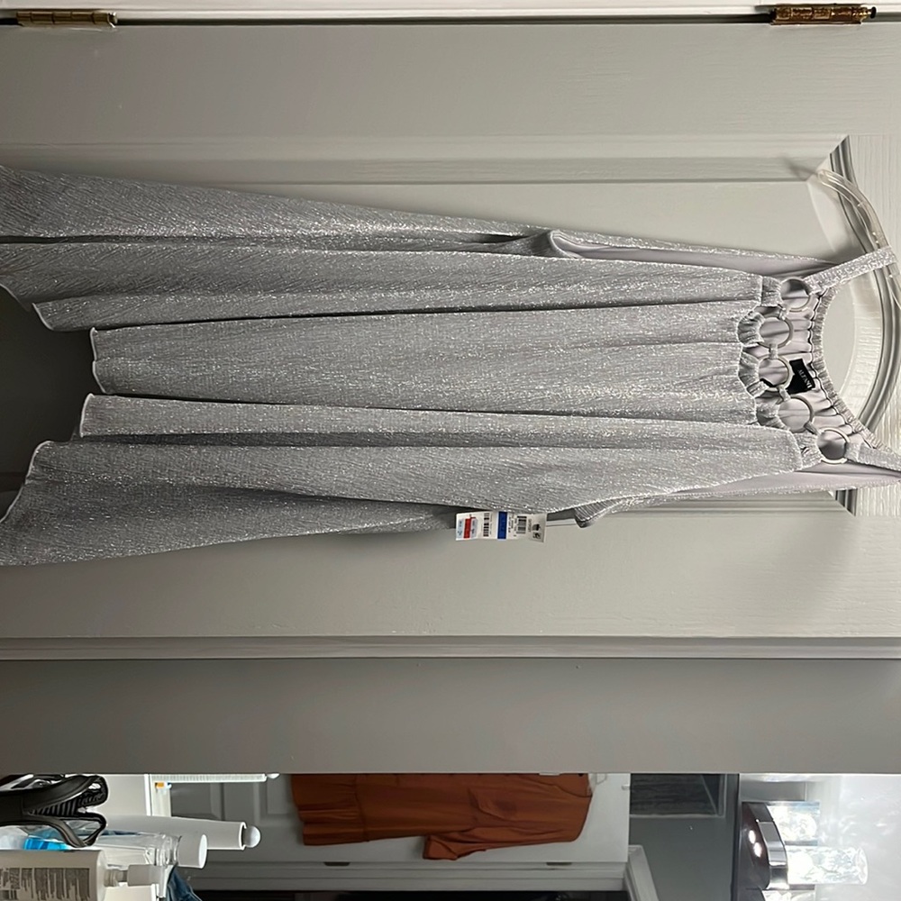 Silver Alfani top with handkerchief bottom. Silver ring detailing at the top.